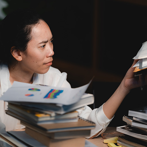 Late night freelancer, Dedicated Asian woman working overtime on laptop computer, meeting deadlines